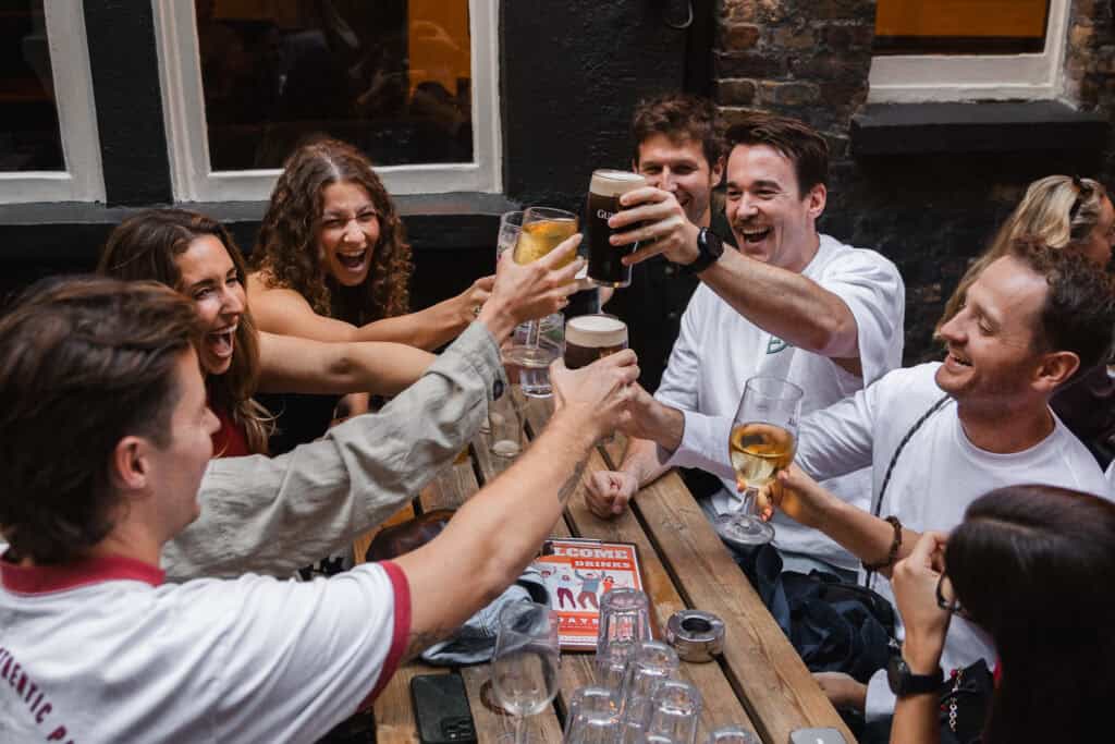 Group of young friends enjoying drinks together at Mitte Hostel Berlin.