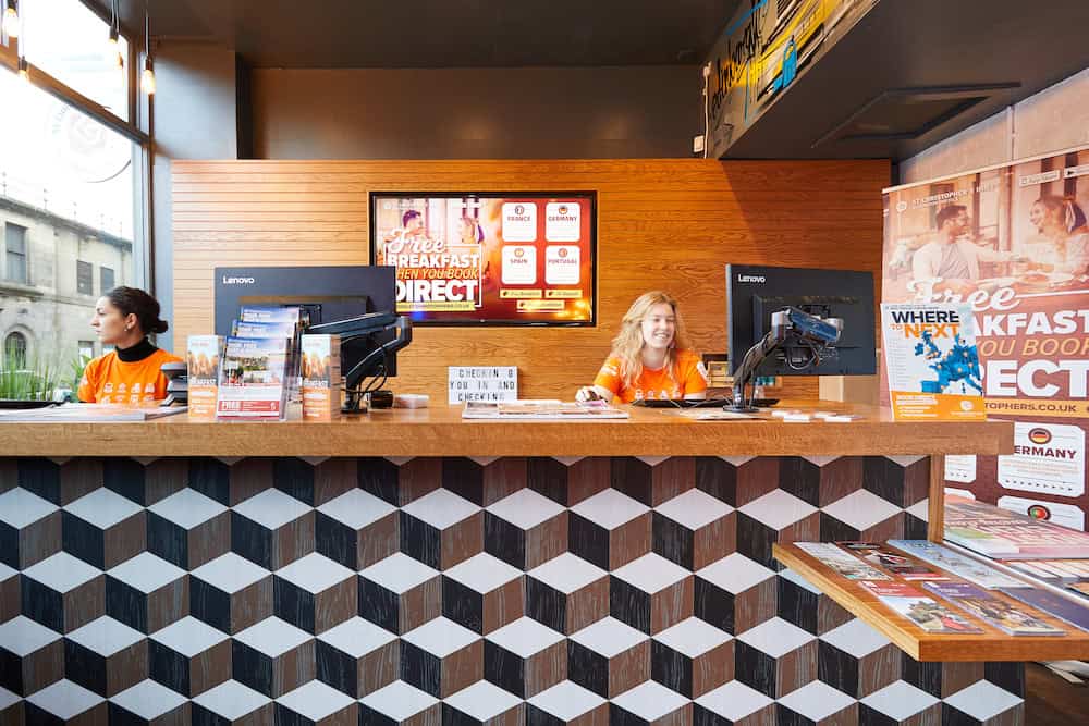 Hostel reception area at St Christopher’s Berlin - Mitte with friendly staff and check-in counters.