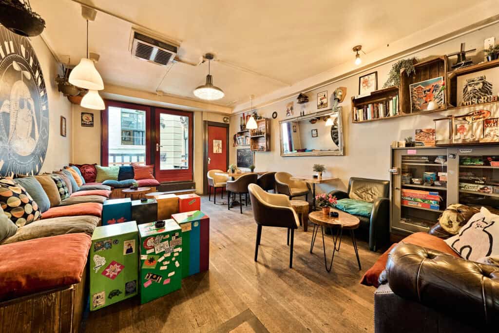 Interior view of the cozy lounge at St Christopher’s Berlin hostel in Mitte, featuring comfortable s.