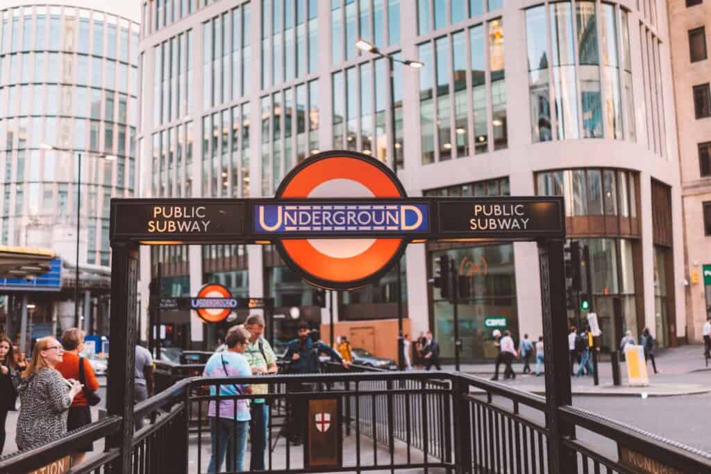 London Underground entrance with busy crowd and iconic signage in the city.