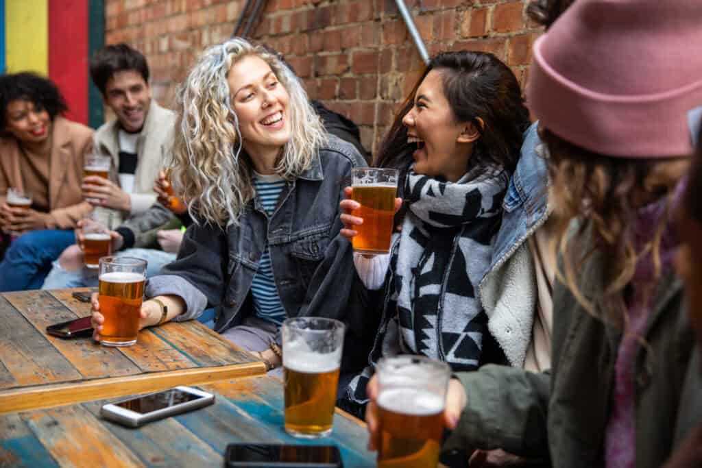 Group of friends enjoying drinks at a lively bar in Berlin Mitte.