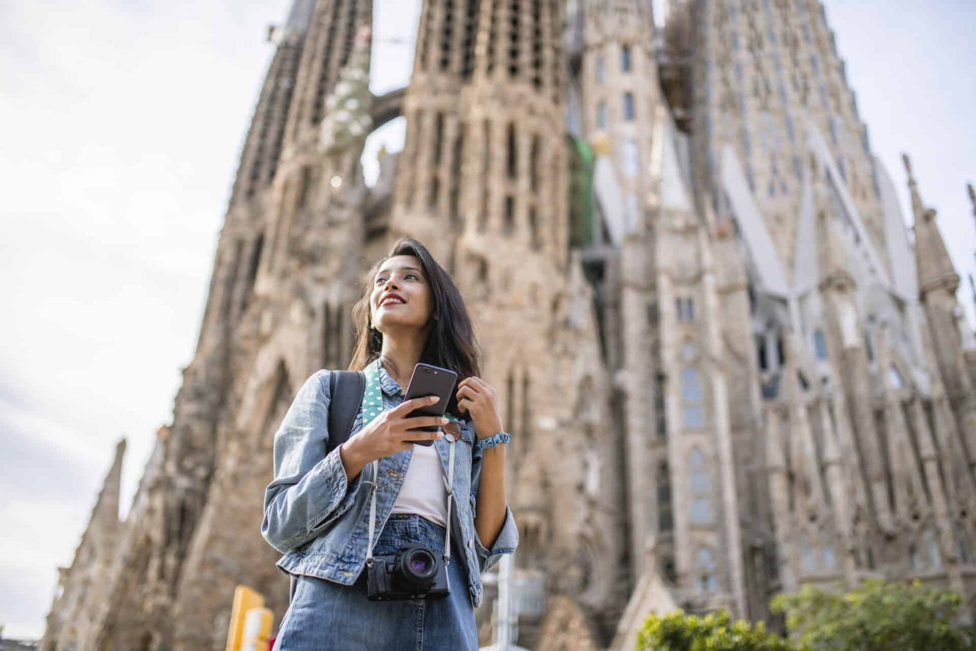 Young woman sightseeing near Berlin Cathedral, showcasing Mitte Hostel location in Berlin.