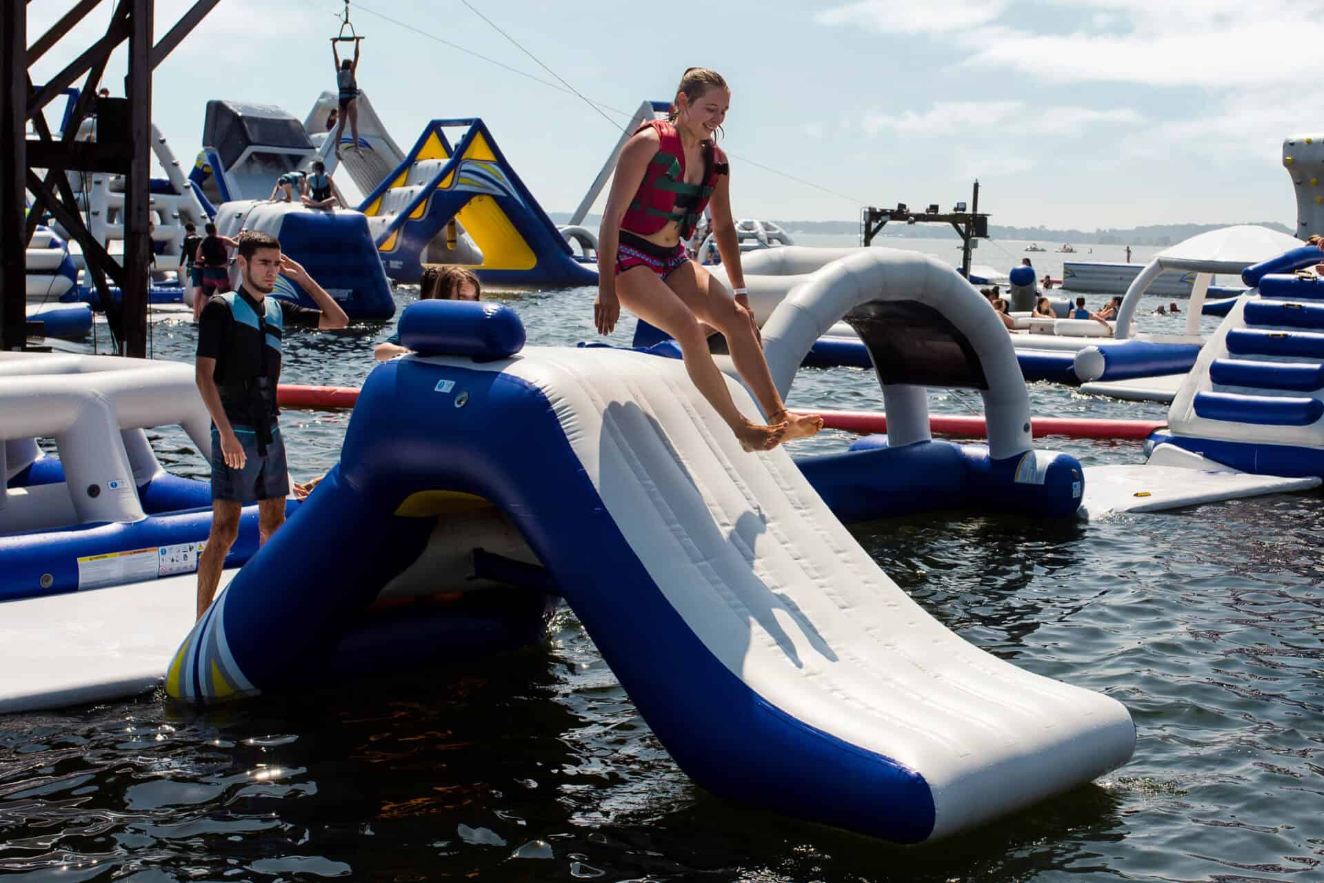 A girl sliding down an inflatable water slide at Mitte Hostel, Berlin, with other water activities n.