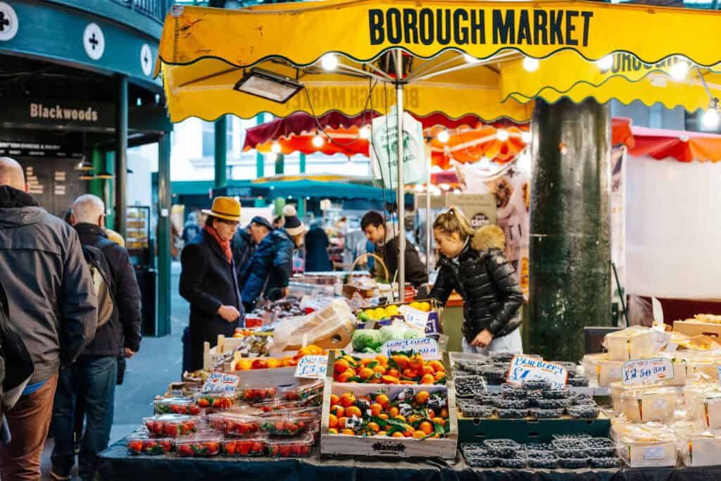 Bustling Borough Market stall with fresh fruits and vegetables in Berlin, lively atmosphere and dive.