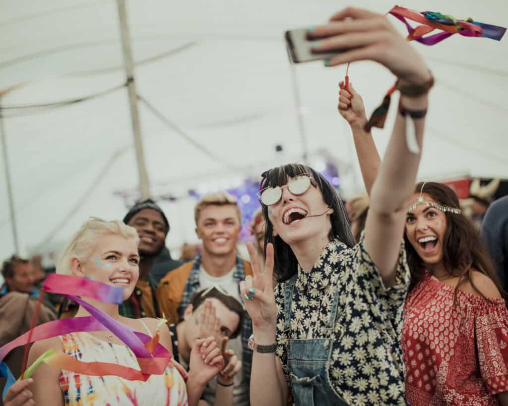 Group of cheerful young people taking a selfie at Mitte Hostel Berlin, enjoying a lively atmosphere.