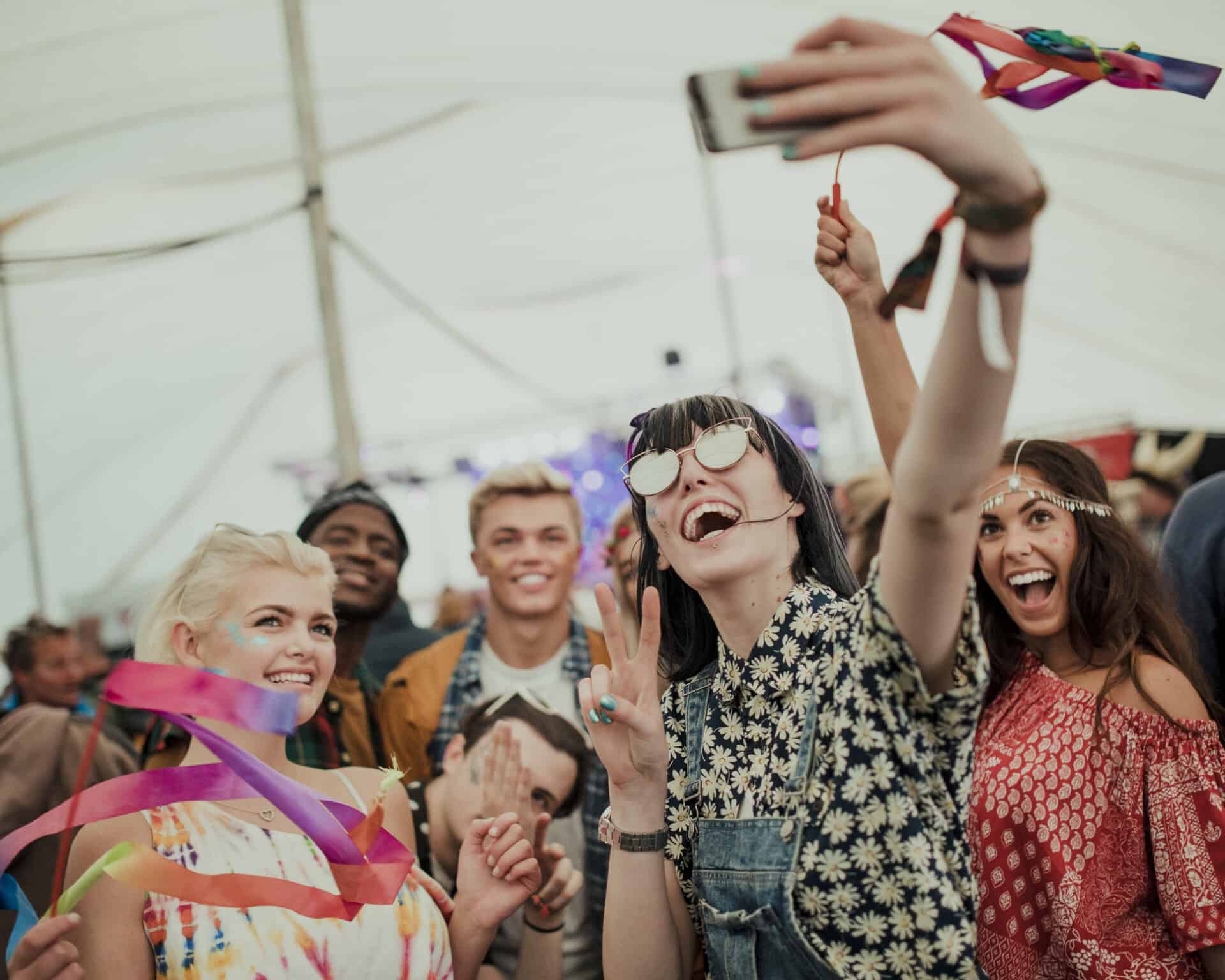 Group of cheerful young people taking a selfie at Mitte Hostel Berlin, enjoying a lively atmosphere.