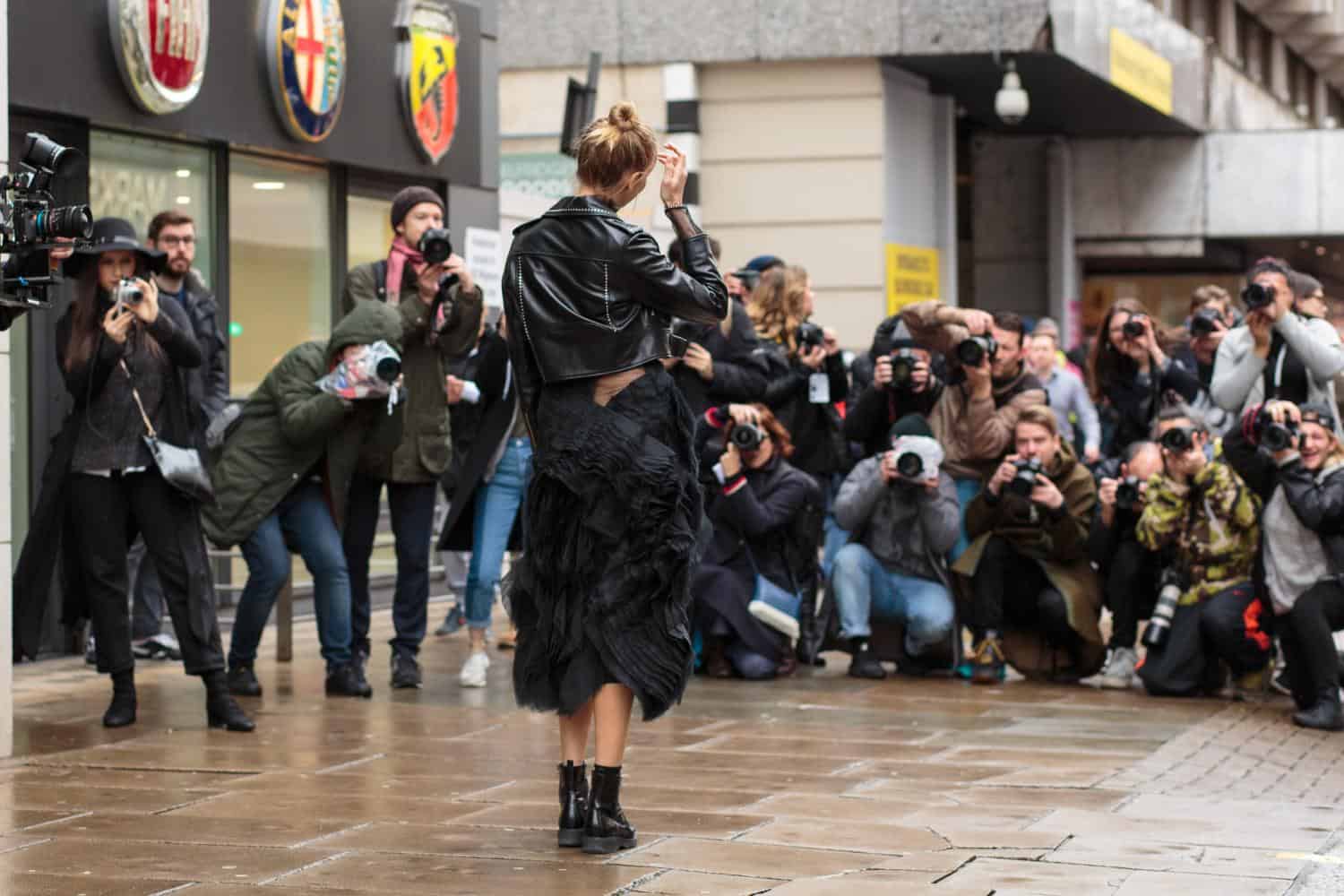Street performer surrounded by photographers outside Mitte Hostel Berlin, capturing a lively urban m.