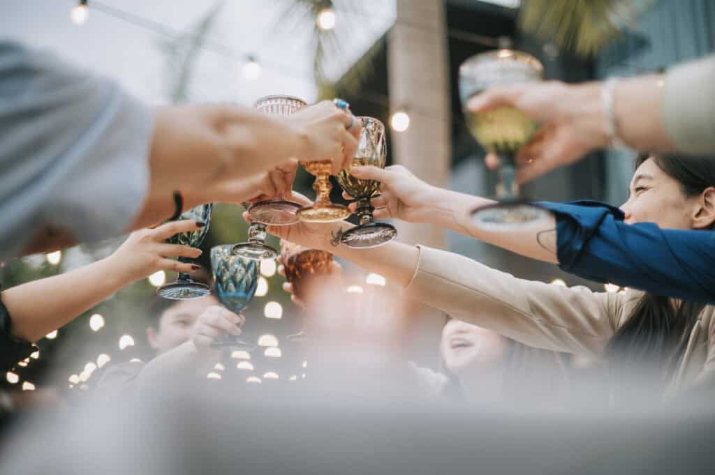 Group of friends clinking glasses at a celebration in Berlin Mitte.